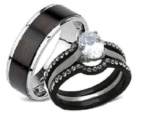 A black and silver wedding ring set featuring a matte black band with a polished silver edge, a matching black and silver band with small clear stones, and a solitaire clear round gemstone.